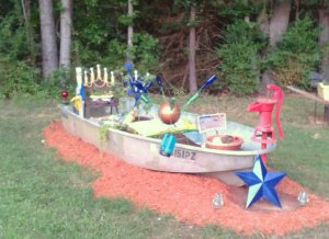 "I started adding soil and more items from the yard. Lots and lots of garden soil. I added Lantana in the back, since they will eventually be large - red/white& blue wave petunias & red gerbera daisies," Jimmye says.